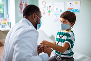 doctor examining young boy 