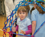 Image of a group of kids playing in an expandable sphere