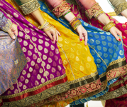 Image of women wearing multi-colored sarees