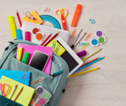 Image of backpack with school supplies like pencils, scissors, highlighters and more coming out of its pockets