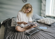 woman sitting on her bed