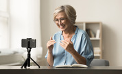 older woman in front of a camera