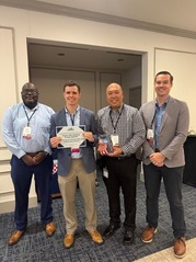 VAEEC award certificate with men holding and posing