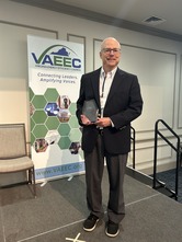 john morrill posing with his award