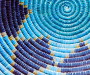 Image of a blue woven basket with a diamond design. 