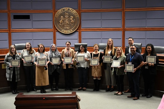 team in board chambers posing for photo