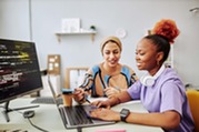 young teenager and young woman looking at the computer together