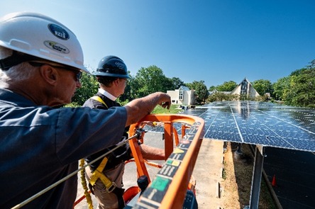 two men looking at solar panels