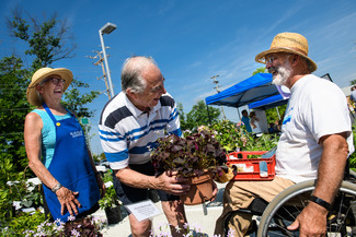 three peopl laughing at a farmers markete