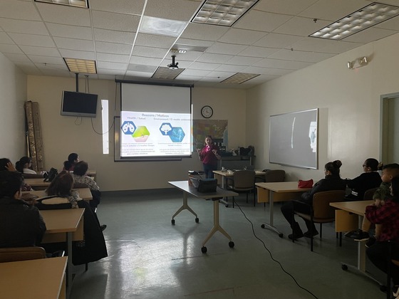 OEEC staff member Sara presenting next to a projector