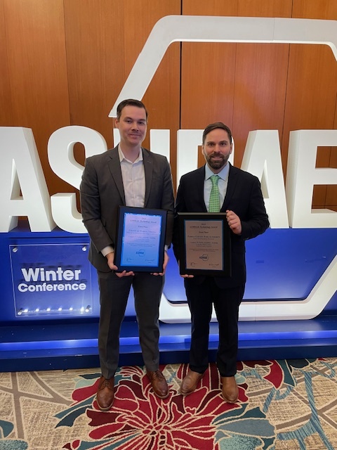 men holding framed certificates