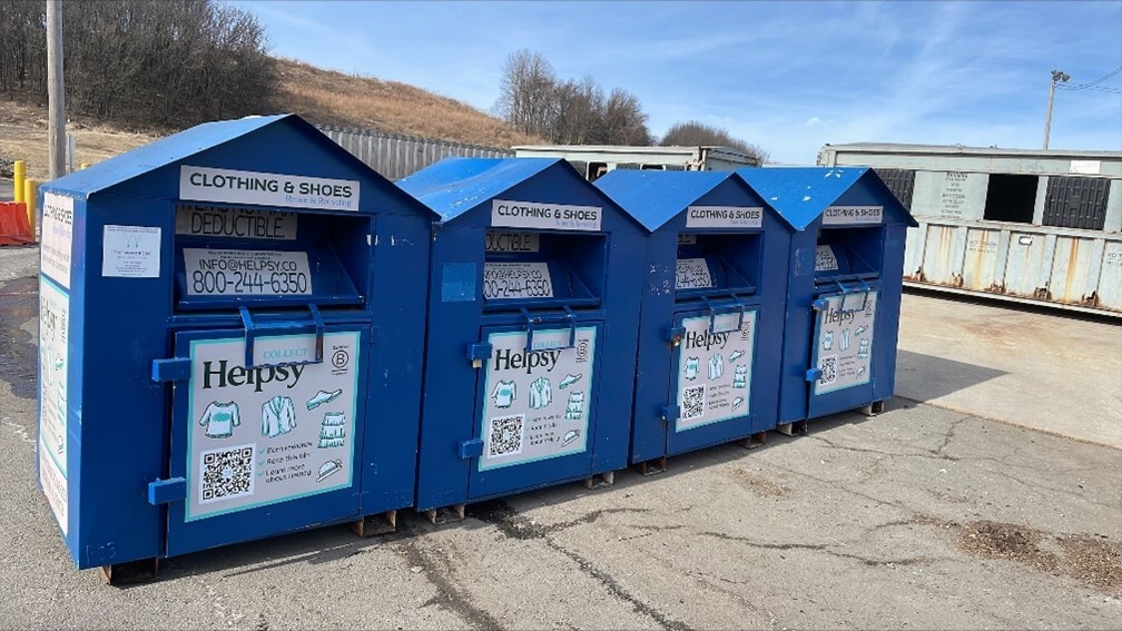 photos of 4 blue clothes collection bins