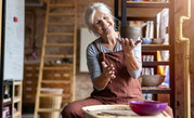 older woman making pottery