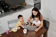 woman sitting at the table with children