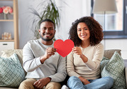 couple holding a paper heart