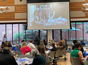 dinner gathering with large screen in background