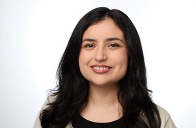 stephanie's headshot - woman wearing a black and white shirt