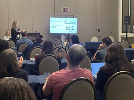 maggie and allison presenting to a room of people