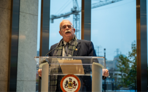gerry connolly at a podium with the fairfax county seal