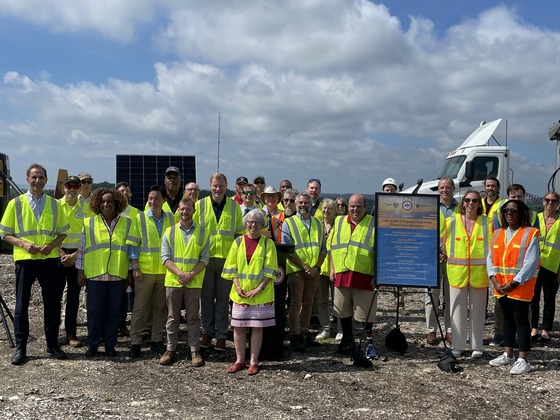 people in high visibility vest posing for group photo