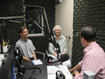 photo of three people in a recording booth