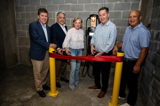 photo of ribbon cutting event for an EV charger with 5 people