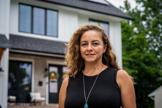 photo of Mona in front of her home