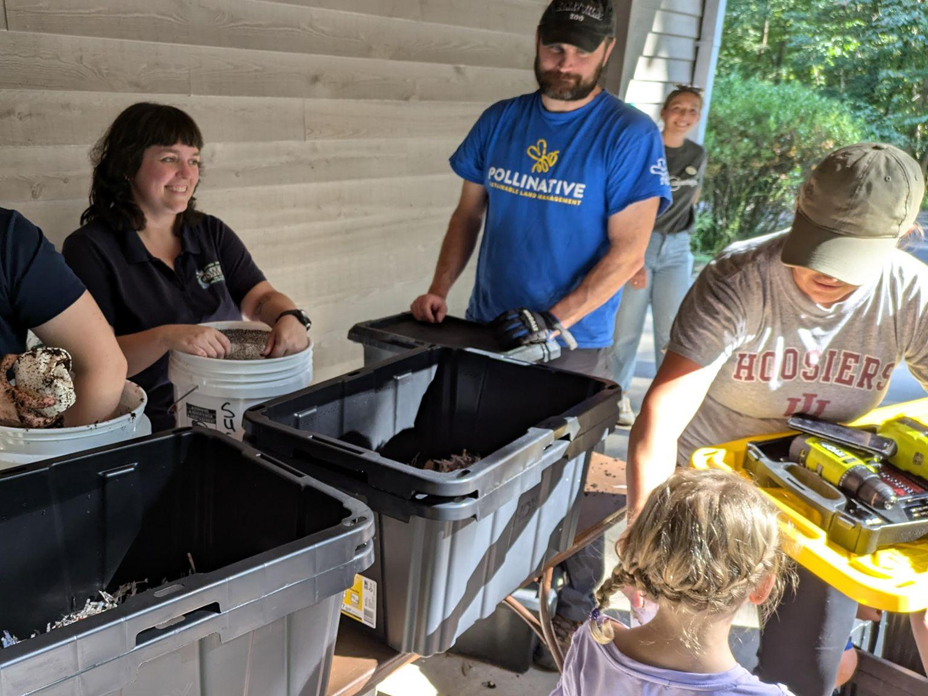 photo of people creating a worm composting bin