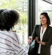 two women shaking hands