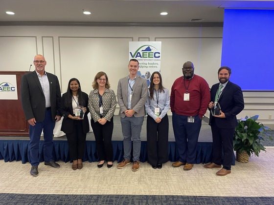 group photo of staff and consultants holding their award