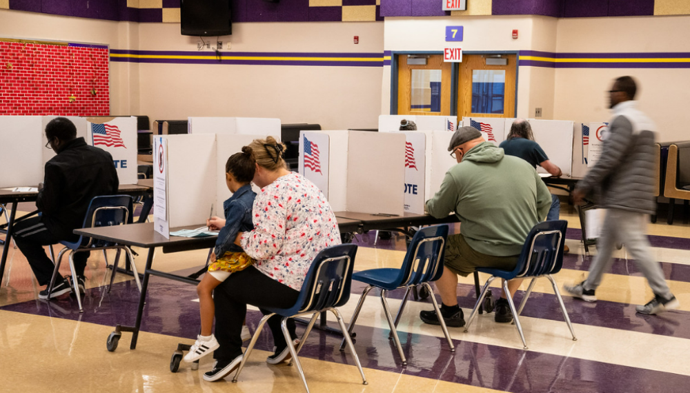 People voting behind dividers.