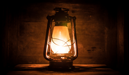 A lantern with a glowing orange light. 