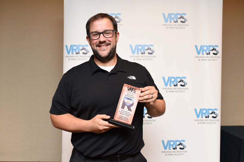 NCS Operations Manager Spencer Collier accepts the award for Best New DEI Initiative.  