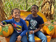 two kids with pumpkins