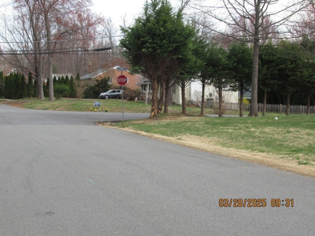 The same intersection after the tree was trimmed to make it easier to see the stop sign.