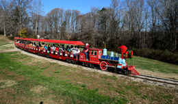 The red Holiday Express trains cuts through Burke Lake Park.