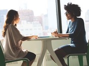 two people sitting by the window