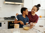 smiling boy and woman cooking