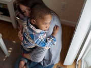 woman holding and comforting boy
