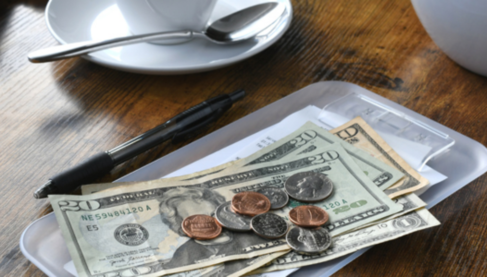 A check with dollars and change on top of it.