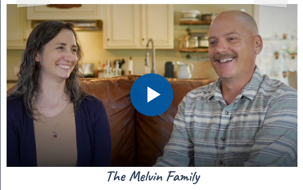 Smiling woman and man sitting on couch