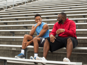 teen and adult on bleachers