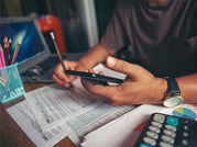 person with calculator and tax paperwork