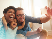 multi-racial family taking selfie