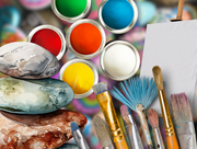 Painted rocks with paint brushes and paint pots