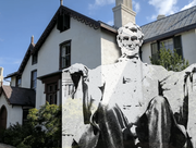 Photo of President Lincoln's statue from the Lincoln memorial in front of a photo of his cottage in Washington D.C.