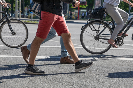 photo of feet walking and biking on a road