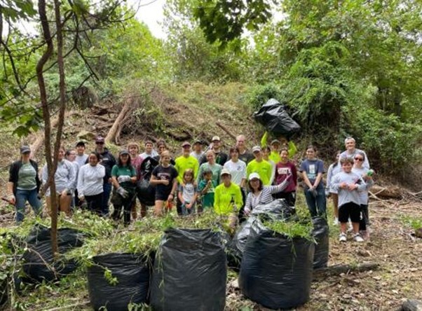 photo of group of volunteers removing invasive plants