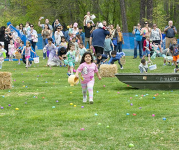 A child holds an Easter basket as they look for eggs at a previous Burke Lake Park egg hunt.