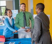 Teens accepting documents at a job fair. 